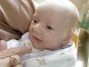 Close up of Annabelle, in Grandma Margie's arms, in Granny's kitchen.